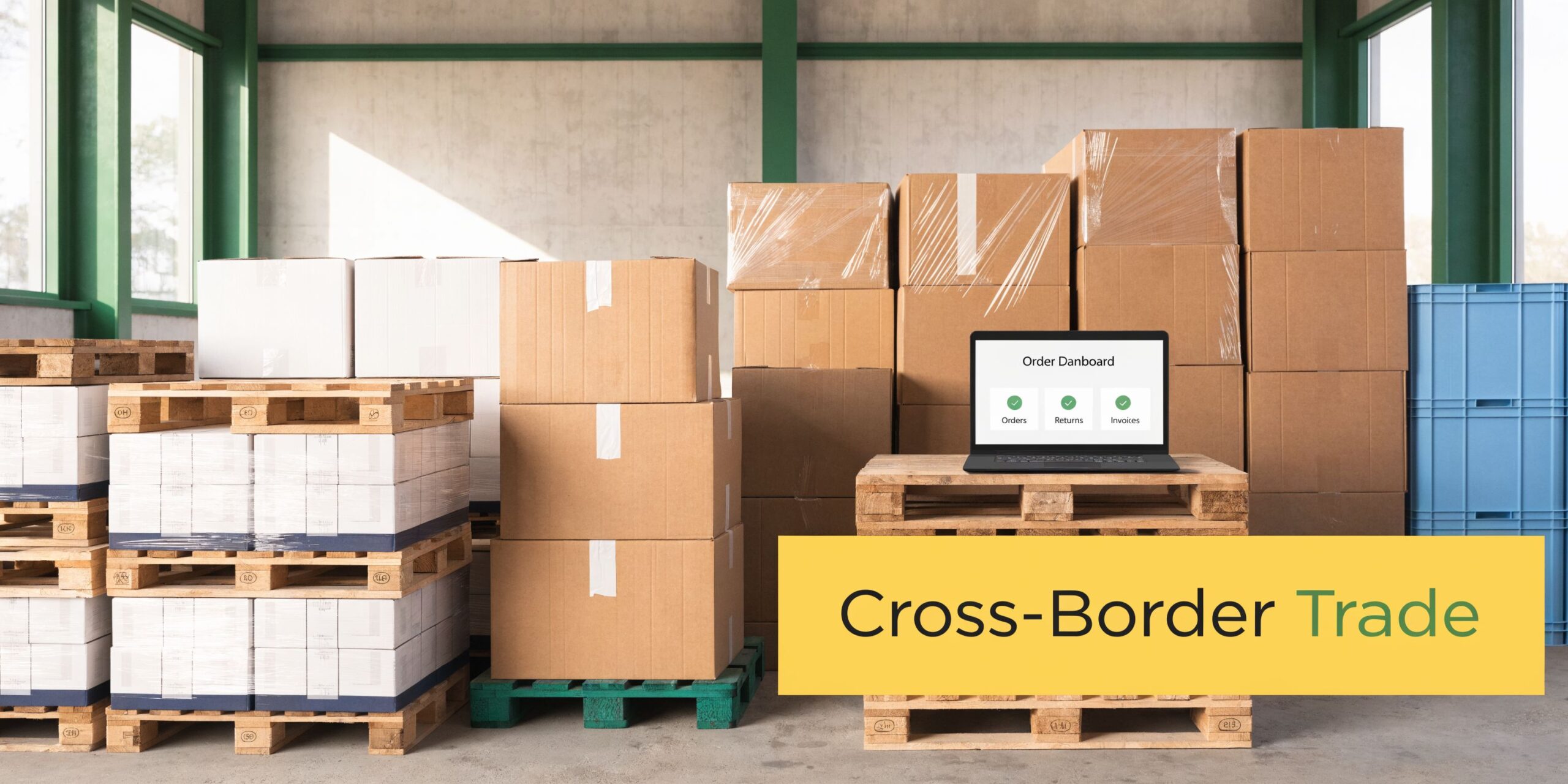 A warehouse scene featuring stacked cardboard boxes on wooden pallets and a laptop displaying order management software.