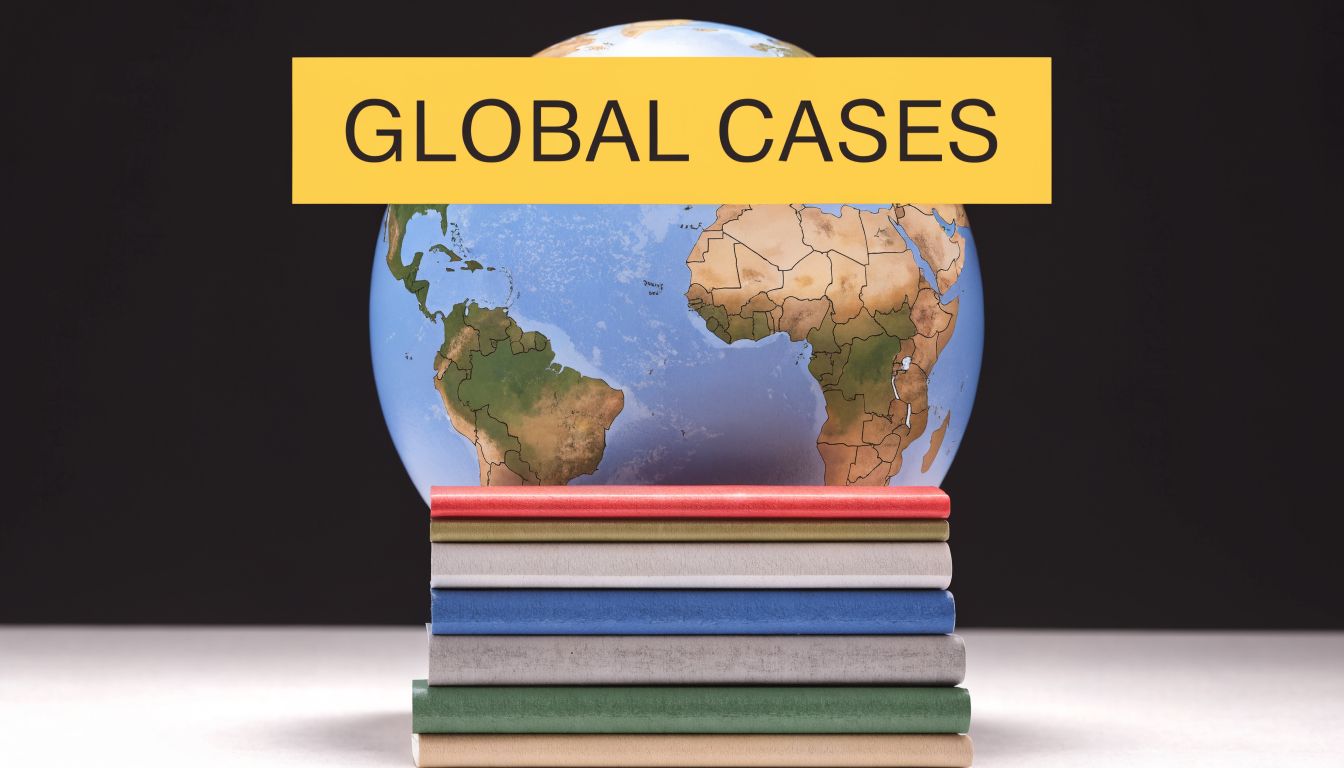 A stack of colorful books with a world globe placed behind them representing global legal issues.