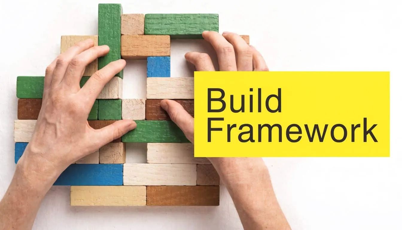 A person's hands carefully arranging wooden building blocks on a white surface with a yellow text overlay.