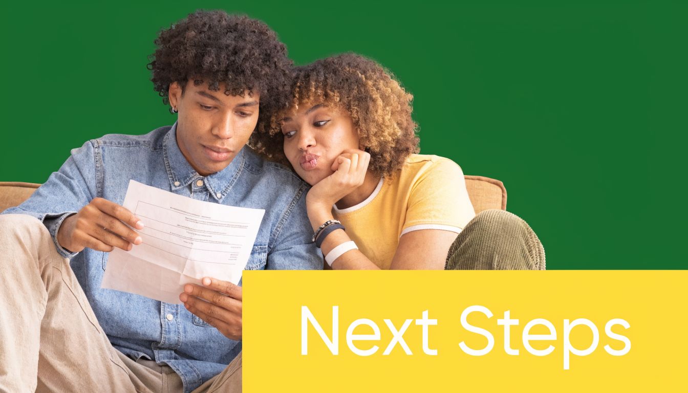 A young couple sitting together and reviewing official documents with a concerned expression.