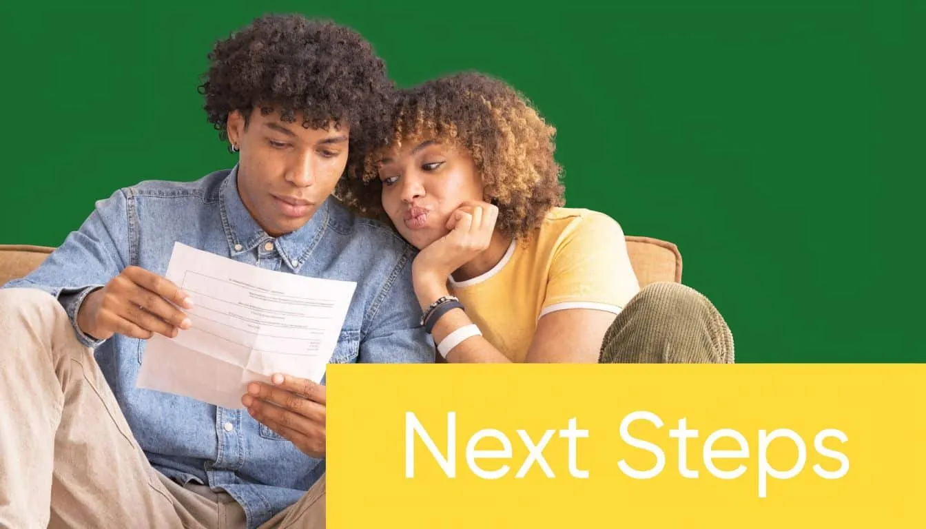 A young couple sitting together and reviewing official documents with a concerned expression.